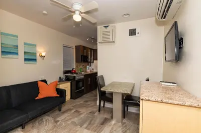 a living room with a couch and a table at Caribbean Resort by the Ocean in Hollywood