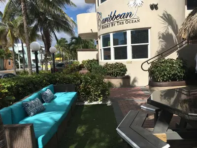 a blue couch sitting in front of a building at Caribbean Resort by the Ocean in Hollywood