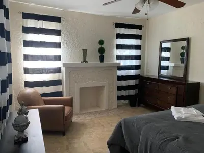 a bedroom with a bed and a fireplace and a mirror at Cozy rooms in cute house, close to Miami airport - Free parking in Miami