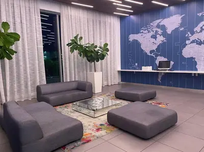 a living room with a map of the world on the wall at Seaside Studio Comfort Great for Small Groups in Hallandale Beach