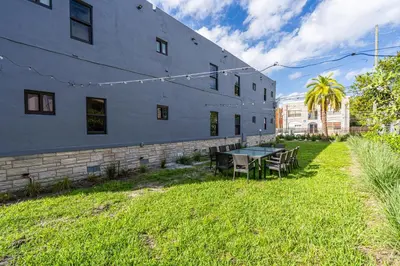 a building with a table and chairs in the grass at Spectacular Apartment near Brickell in Miami