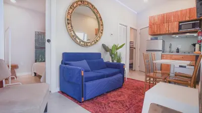 a blue couch in a living room with a mirror at Spectacular Apartment near Brickell in Miami