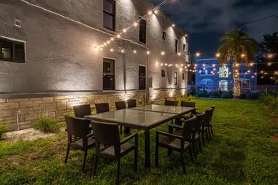 a table and chairs in front of a building at night at Spectacular Apartment near Brickell in Miami