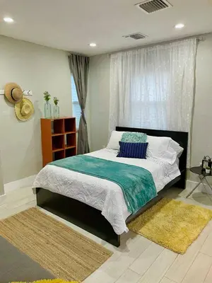a bedroom with a large bed and a window at Orange You Glad you came in Miami