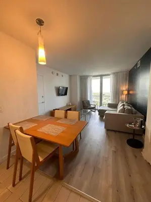 a living room with a dining room table and a couch at Miami Beach, Full Kitchen & Style -A in Hallandale Beach
