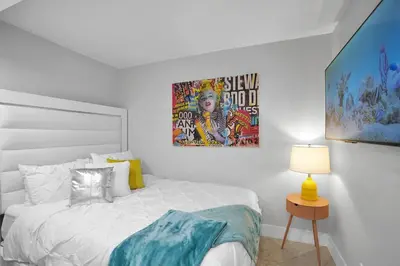 a bedroom with a bed and a painting on the wall at Euphoria - Miami Skyline & Water Views in Miami