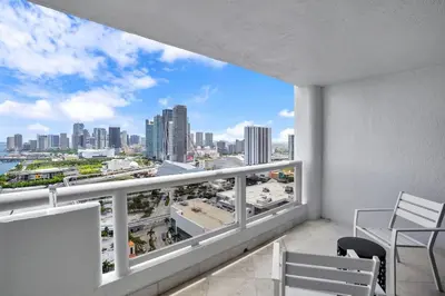 a balcony with chairs and a view of a city at Euphoria - Miami Skyline & Water Views in Miami