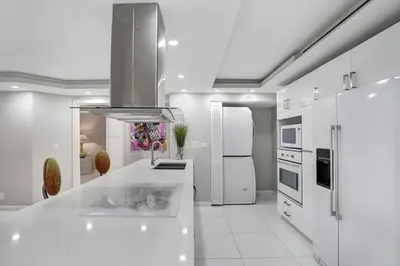 a kitchen with white appliances and a white counter top at Funkin' Fabulous! Water & City Views! 4BR in Miami