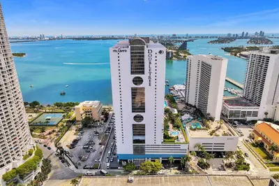 an aerial view of a tall white building next to the water at Stay in Love! Miami Skyline Views, Renovated in Miami