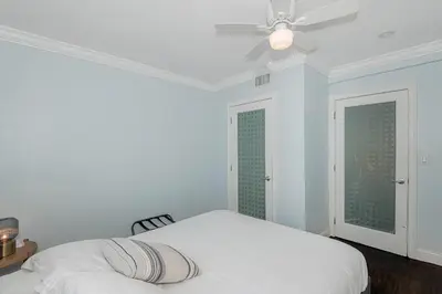 a white bedroom with a bed and a ceiling fan at Miami Dream Home/ Pool/Jacuzzi/ Fire Pit in Miami
