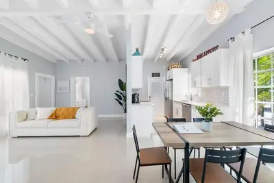 a white living room with a table and a couch at Together but with Privacy 3 Units and Private Pool in Fort Lauderdale
