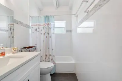 a white bathroom with a toilet and a sink at Together but with Privacy 3 Units and Private Pool in Fort Lauderdale