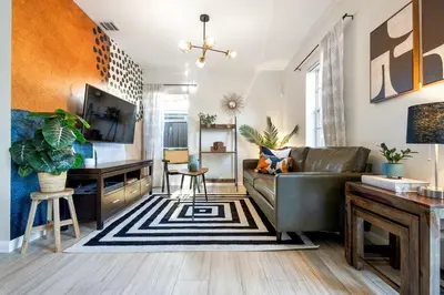 a living room with a couch and a desk at Casa Limon - Private Heated Pool Prime Location & Parking in Fort Lauderdale