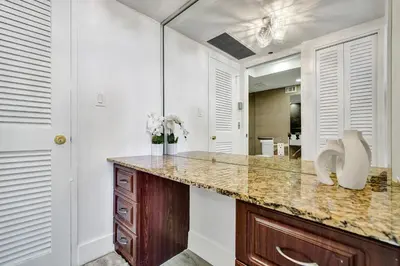 a bathroom with a counter and a mirror at Breathtaking resort condo w beach service Unit 908 in Miami Beach