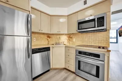 a kitchen with a stainless steel refrigerator and microwave at Breathtaking resort condo w beach service Unit 908 in Miami Beach
