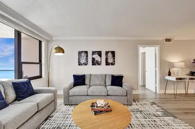 a living room with a couch and a table at Breathtaking resort condo w beach service Unit 908 in Miami Beach