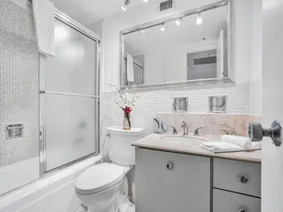 a bathroom with a toilet and a sink and a shower at Cozy 2 Bedroom Ocean View Beach Service 707 in Miami Beach