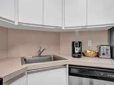 a kitchen with a sink and a microwave at Cozy 2 Bedroom Ocean View Beach Service 707 in Miami Beach