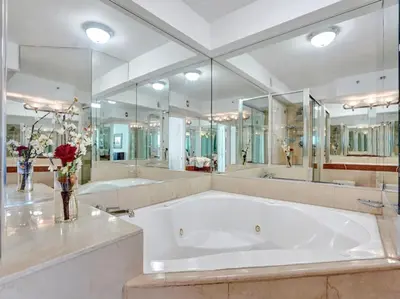 a large bathroom with two sinks and a large tub at Huge Terrace Oceanfront Condo Beach Service 1502 in Miami Beach