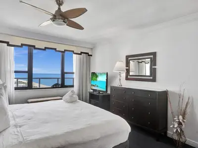 a bedroom with a large bed and a television at Huge Terrace Oceanfront Condo Beach Service 1502 in Miami Beach