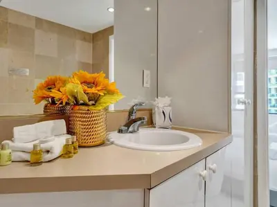 a bathroom counter with a sink and a mirror at Fantastic condo w beach service 615 in Miami Beach