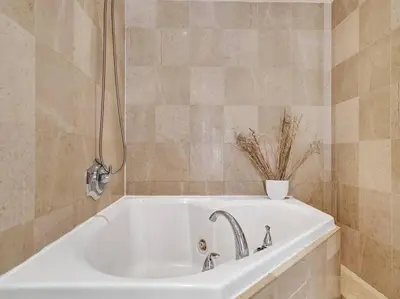 a white bath tub with a vase on top of it at Fantastic condo w beach service 615 in Miami Beach
