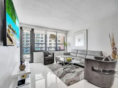 a living room with a couch and a table at Fantastic condo w beach service 615 in Miami Beach
