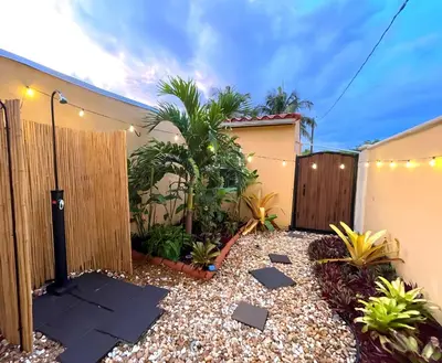 a backyard with a fence and some plants at Fun Getaway: Hot Tub, Tiki Bar, Arcade Room in Hollywood