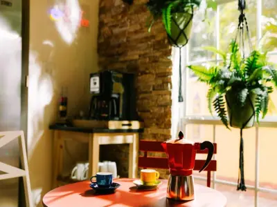 a table with a coffee pot and cups on it at Fun Getaway: Hot Tub, Tiki Bar, Arcade Room in Hollywood