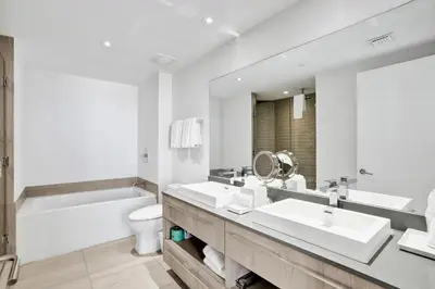 a bathroom with two sinks and a tub and a toilet at 2BR & 2BA Corner Suite Ocean Views at Hyde Beach House in Hollywood