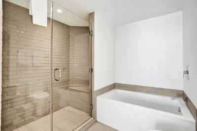 a bathroom with a tub and a glass shower at 2BR & 2BA Corner Suite Ocean Views at Hyde Beach House in Hollywood