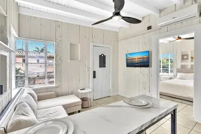 a living room with a couch and a ceiling fan at New Year and Holiday Charming Miami Riverfront Stay! in Miami