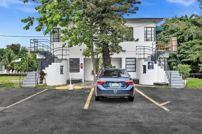 a car parked in a parking lot in front of a building at New Year and Holiday Charming Miami Riverfront Stay! in Miami