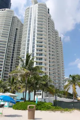 two tall buildings on the beach with palm trees at Marenas LATERAL ocean view daily refresh not included Fees collected at arrival in Sunny Isles Beach