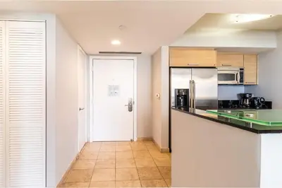 a kitchen with a counter and a refrigerator at Marenas LATERAL ocean view daily refresh not included Fees collected at arrival in Sunny Isles Beach