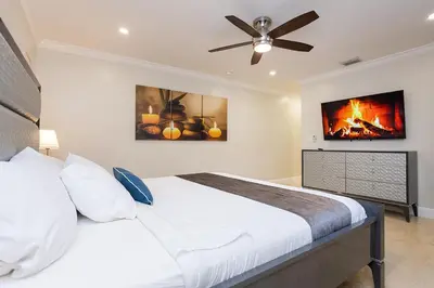 a bedroom with a bed and a ceiling fan at Ultimate Luxury 5BR Villa near Hollywood Beach in Hollywood