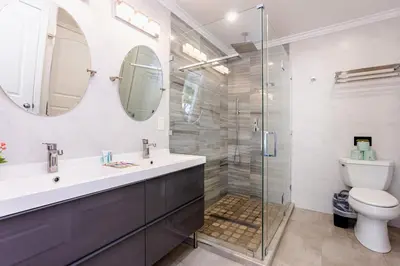 a bathroom with a shower and a sink and a toilet at Ultimate Luxury 5BR Villa near Hollywood Beach in Hollywood