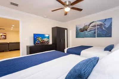 a bedroom with two beds and a flat screen tv at Ultimate Luxury 5BR Villa near Hollywood Beach in Hollywood
