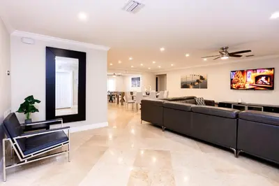 a living room with couches and a dining room at Ultimate Luxury 5BR Villa near Hollywood Beach in Hollywood