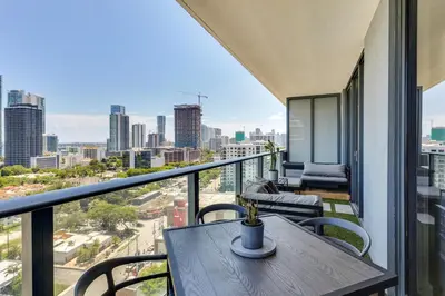 a table on a balcony with a view of the city at High-End Miami Condo with City and Bay Views!!! in Miami