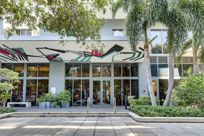 a building with palm trees in front of it at High-End Miami Condo with City and Bay Views!!! in Miami