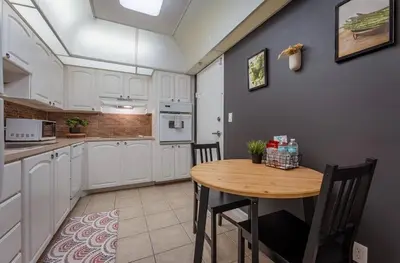 a kitchen with a wooden table and a dining room at Tides Condominiums in Hollywood