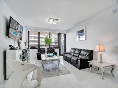 a living room with a couch and a table at Beachfront Condo w Beach Service 1207 in Miami Beach