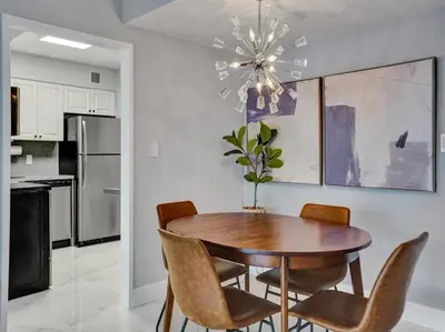 a dining room table and chairs in a kitchen at High Floor Beachfront Condo Beach Service 1509 in Miami Beach
