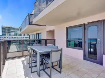 a table and chairs on the balcony of a building at Full ocean view Huge private terrace 1002 in Miami Beach