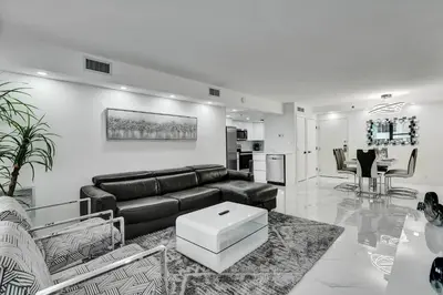 a living room with a couch and a table at Cozy Ocean View Condo Beach Service and Pool 808 in Miami Beach