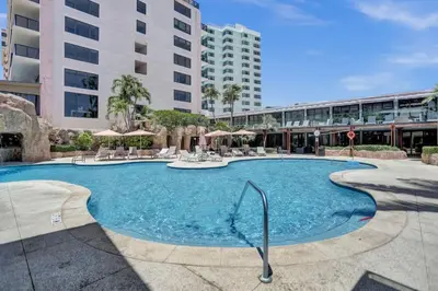 a large swimming pool in front of a building at Cozy Ocean View Condo Beach Service 1015 in Miami Beach