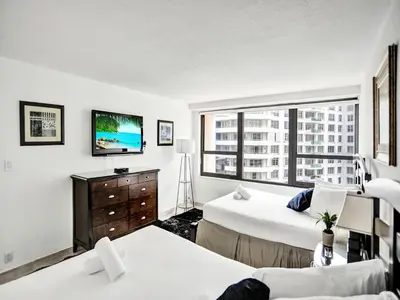 a hotel room with two beds and a tv at Perfect Ocean View Condo Beach Service 1109 in Miami Beach