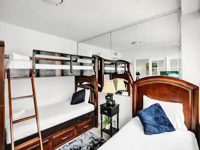 a bedroom with two bunk beds and a lamp at Perfect Ocean View Condo Beach Service 1109 in Miami Beach