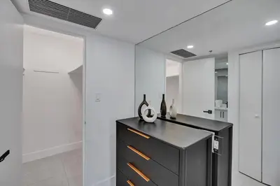 a kitchen with a black counter with vases on it at Relax in Style 3BR 2BA Beach Condo in Oceanfront Resort Pools Gym Sauna 1507 in Miami Beach